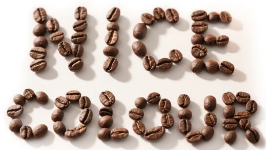 NICE COLOUR — the brand name spelled out in coffee beans